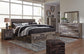 Derekson King Panel Bed with 4 Storage Drawers with Mirrored Dresser, Chest and Nightstand